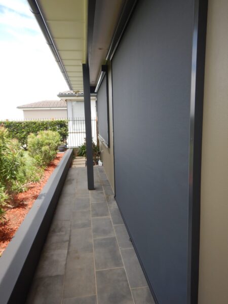 Side on photo of Titan Grey Ziptrak blinds covering a door and window.