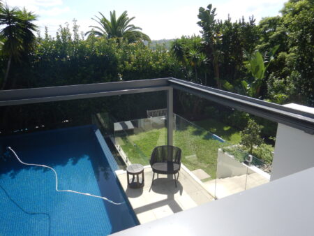 View from above Aluxor Sintesi retractable roof over a pool fully retracted.