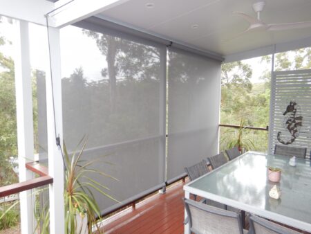 Grey vertical drop blinds closed on deck.