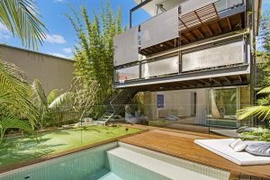 a side image looking front on to the house of drop down blind on the side of a deck.